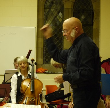 John conducting the orchestra